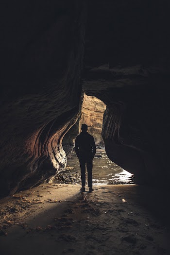 Man Inside Cave Near Entrance 
