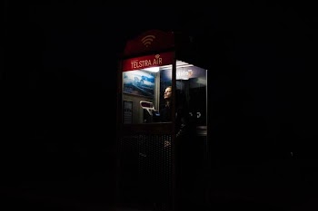 man inside telephone booth