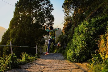 Man Jumping Near Trees