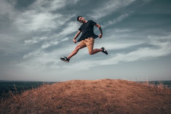 Man Jumping on Brown Soil