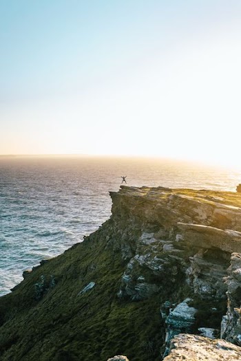 man jumping on cliff