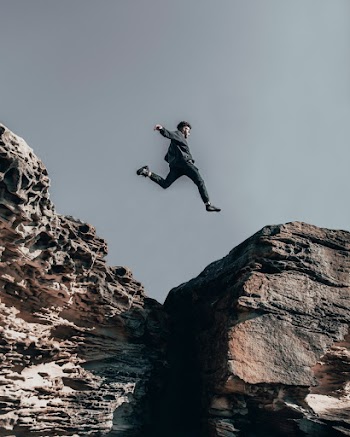 Man Jumping on Rock Formations