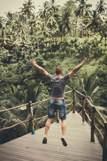 Man Jumping On Wooden Balcony