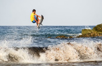 Man Jumping over Water