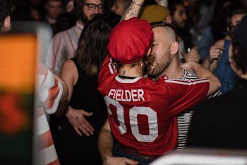 Man Kissing the Woman Wearing Red Shirt