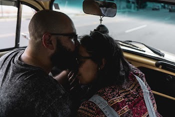 Man Kissing Woman Forehead Inside Car