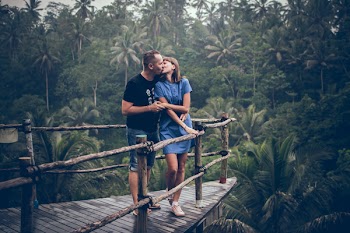 Man Kissing Woman on Cliff