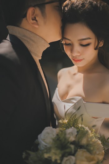 Man Kissing Woman on Forehead