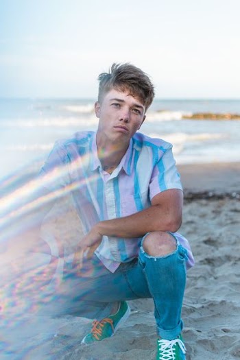 man kneeling down in seashore