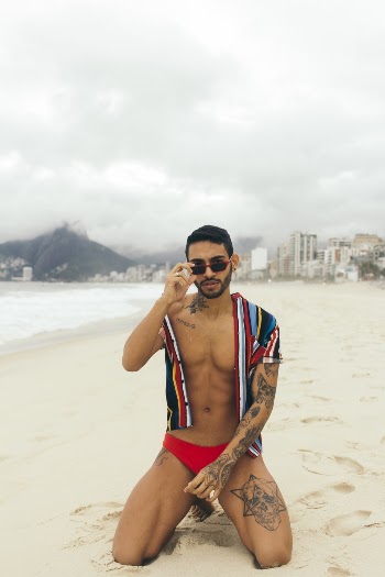 Man Kneeling on Sand