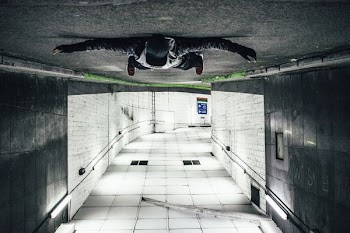 man laying on road tunnel