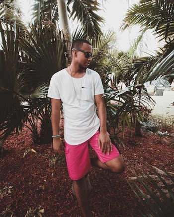 Man Leaning Against Palm Tree