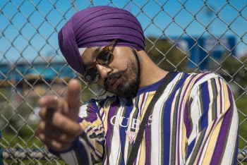 Man Leaning Backward On Wire Fence Doing Hand Gesture