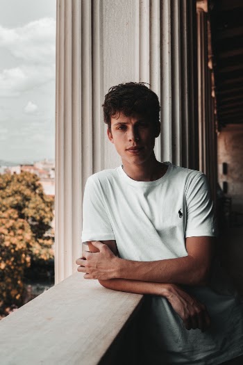Man Leaning Beside Window