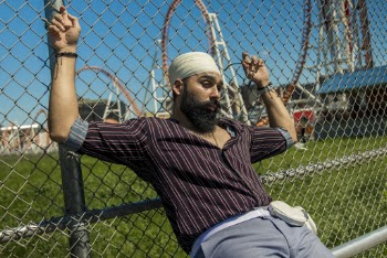 Man Leaning Gray Wire Fence