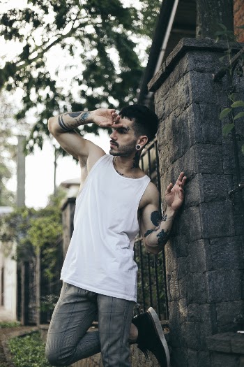 Man Leaning Near Concrete Wall