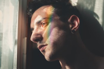 Man Leaning Near Window