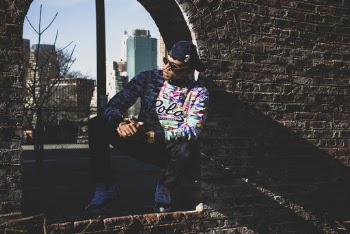 Man Leaning on Brick Wall