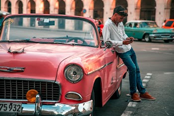 Man Leaning On Classic Car