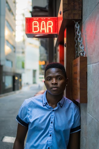 Man Leaning On Concrete Wall