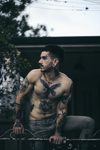 Man Leaning on Fence