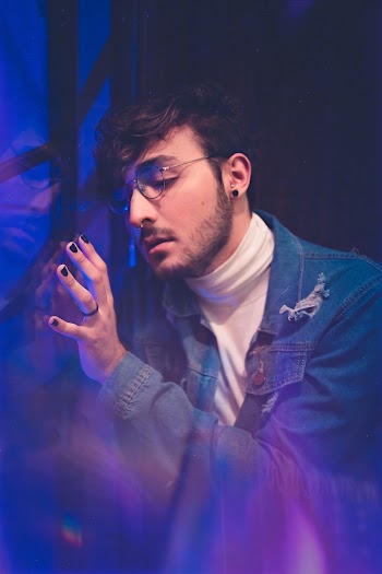 Man Leaning on Glass Wall