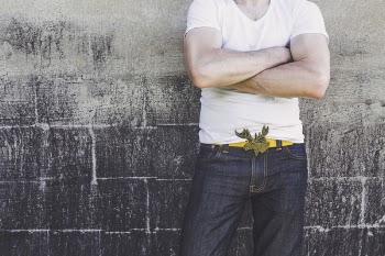 Man Leaning on Gray Wall