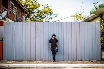 Man Leaning on Gray Wall