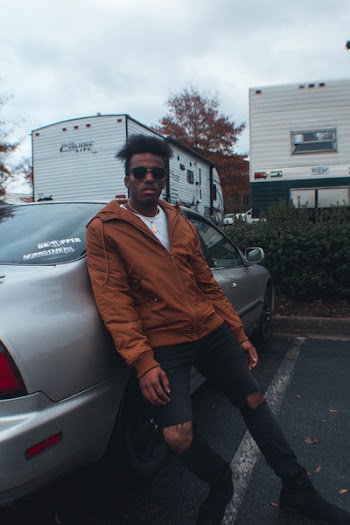 Man Leaning On Grey Sedan