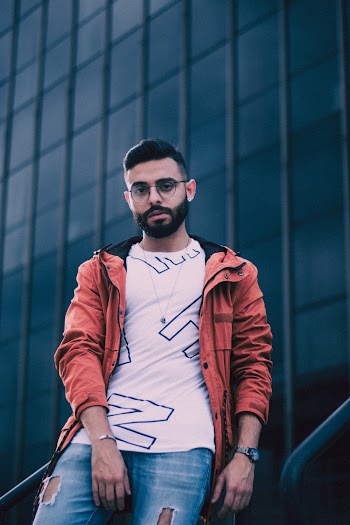 Man Leaning on Metal Railing