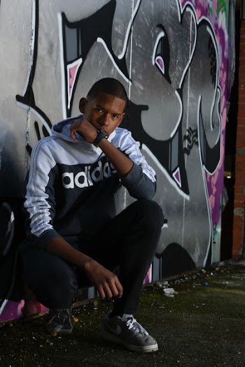 man leaning on painted wall