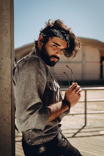 Man Leaning on Post