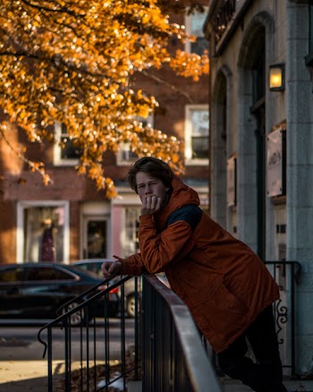 Man Leaning On Railings 