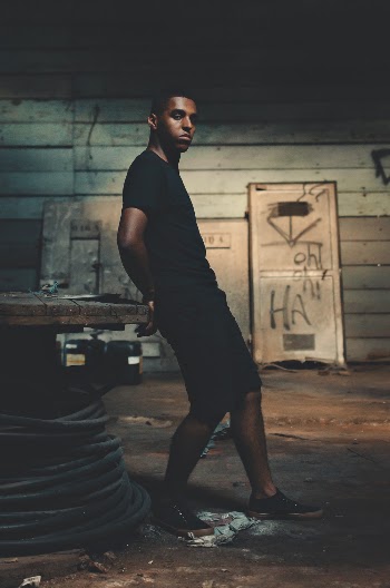 Man Leaning on Spool Table