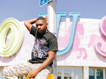 Man Leaning On Street Post