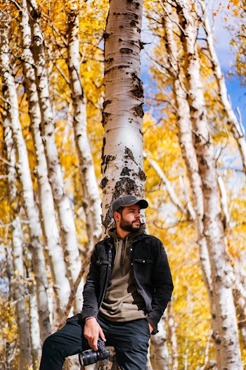 Man Leaning on Tree
