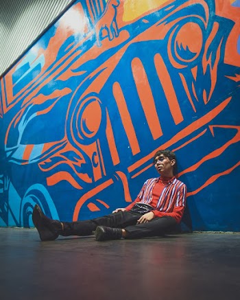 Man Leaning on Wall