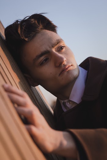 Man Leaning on Wall