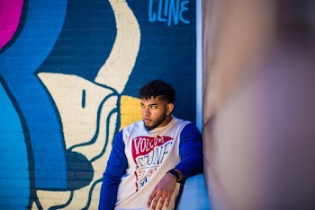 Man Leaning on Wall