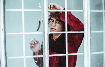 Man Leaning on Window Pane