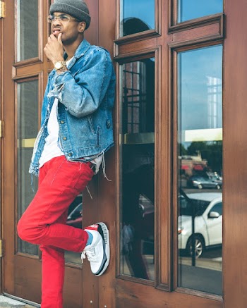 Man Leans on the Door While Holding His Chin