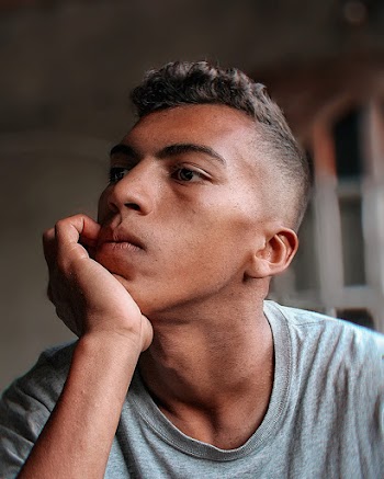 Man Learning His Head to His Hand