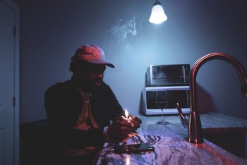 Man Lighting A Cigarette In A Room