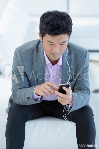 Man listening to music with headphones and smart phone