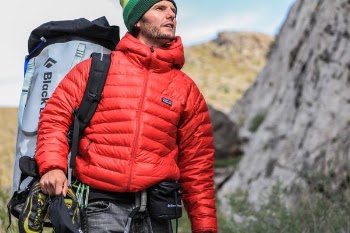 man looking above carrying gray camping backpack