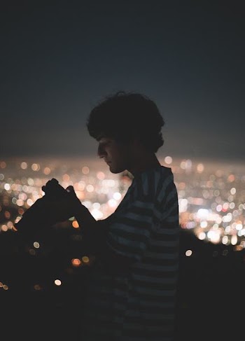man looking at a DSLR camera