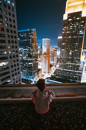 Man Looking At Buildings
