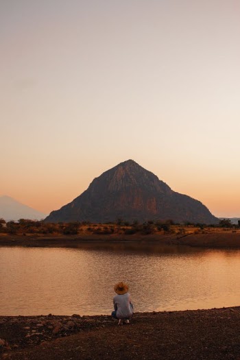 Man Looking at Lonely Mountain and River in Light of Rising Sun · Free Stock Photo