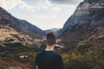 man looking at mountains during daytime