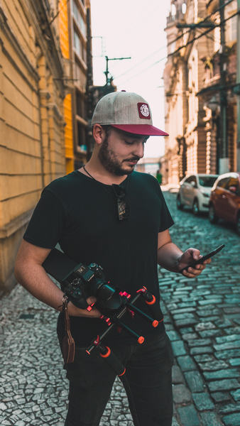 Man Looking at Smartphone at Street